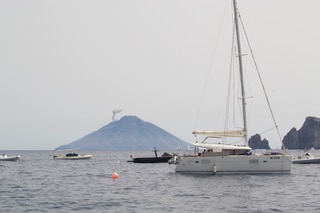 Sailing around the Aeolian Islands with Stromboli erupting in the background